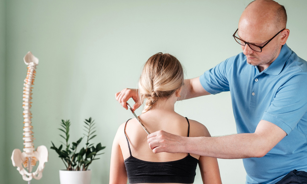 Osteopath providing hands-on soft tissue treatment to a client