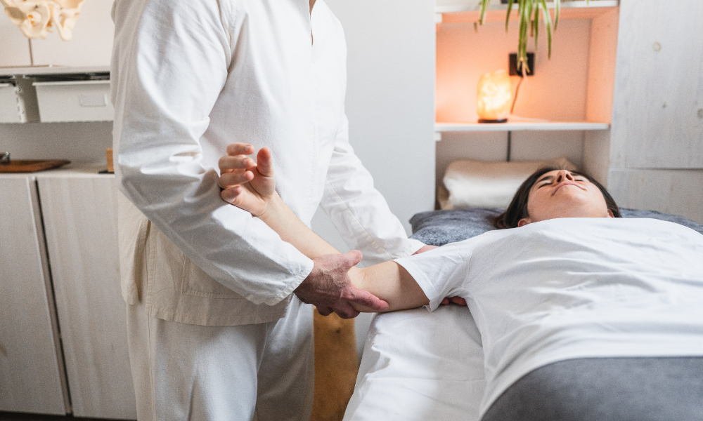 Therapist providing hands-on arm treatment